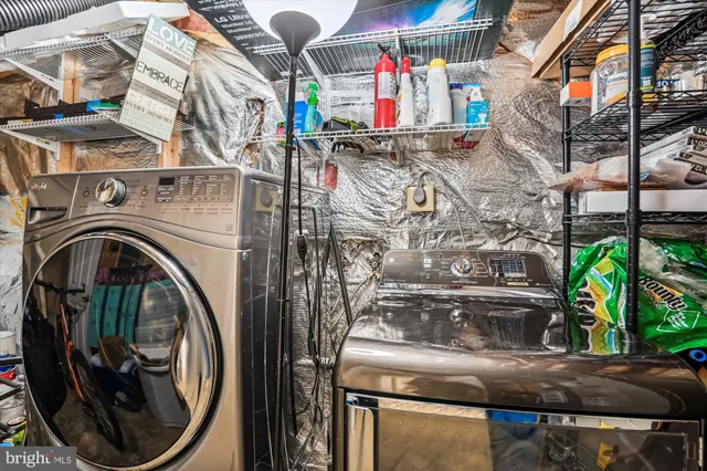 a utility room with lots of clutter and washer