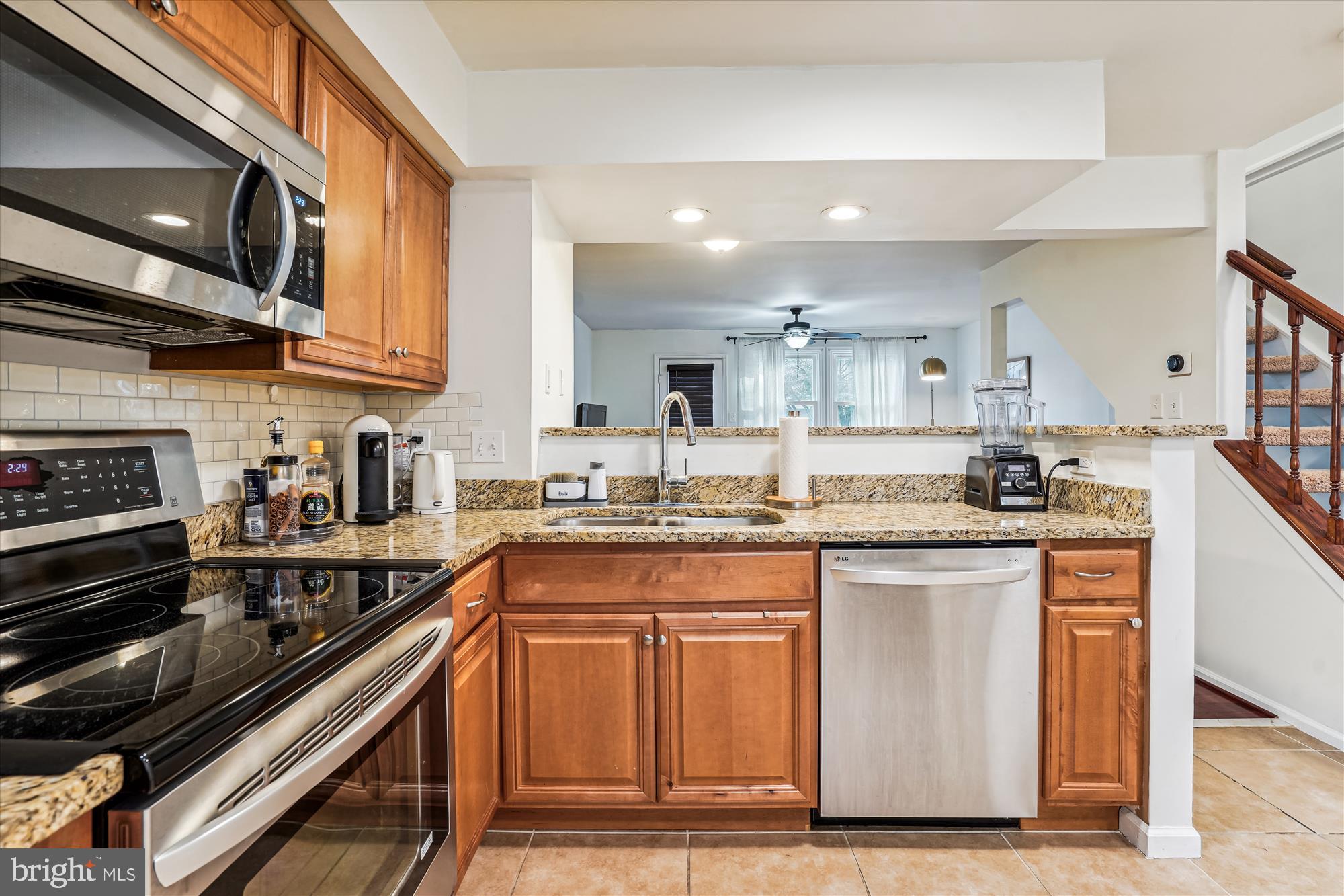 5039 9th Street South Arlington, VA 22204 - Photo 6 of 38 a kitchen with stainless steel appliances granite countertop a stove a sink and a microwave