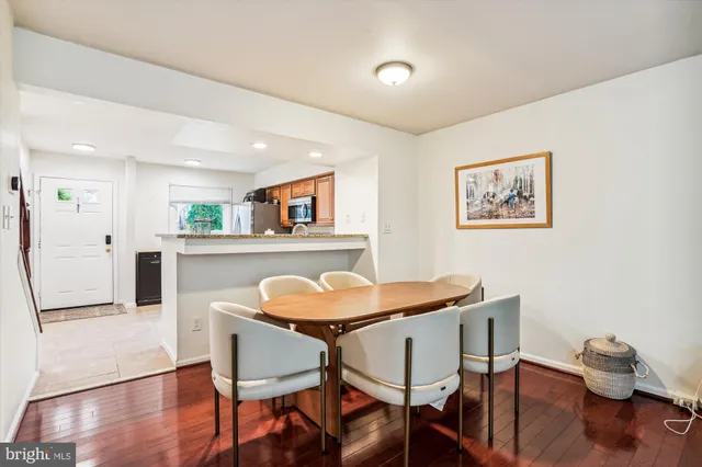 a view of a dining room with furniture and wooden floor