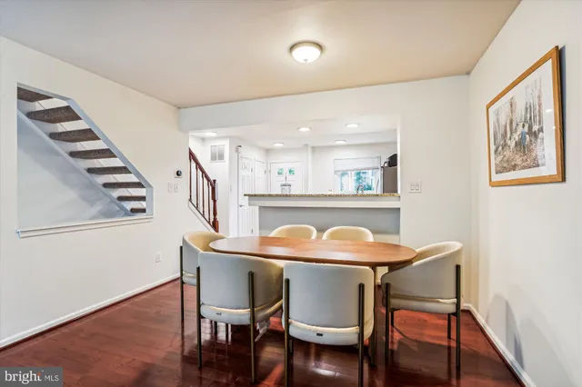 a dining room with furniture and wooden floor