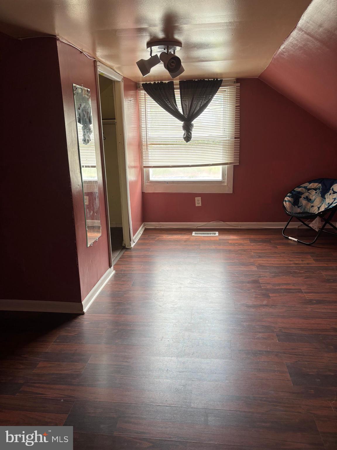 3015 Chesley Avenue Baltimore, MD 21234 - Photo 12 of 30 a view of an empty room with wooden floor and stairs