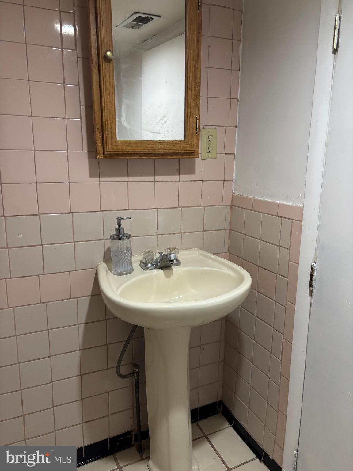 3015 Chesley Avenue Baltimore, MD 21234 - Photo 14 of 30 a bathroom with a sink and a mirror