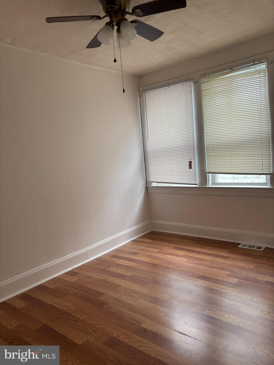 3015 Chesley Avenue Baltimore, MD 21234 - Photo 6 of 30 an empty room with wooden floor and windows
