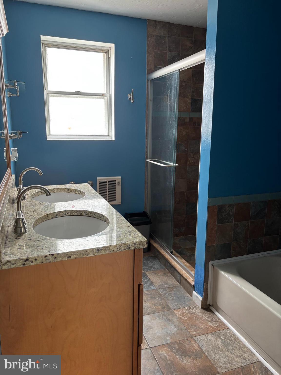 3015 Chesley Avenue Baltimore, MD 21234 - Photo 7 of 30 a bathroom with a granite countertop sink and a bathtub