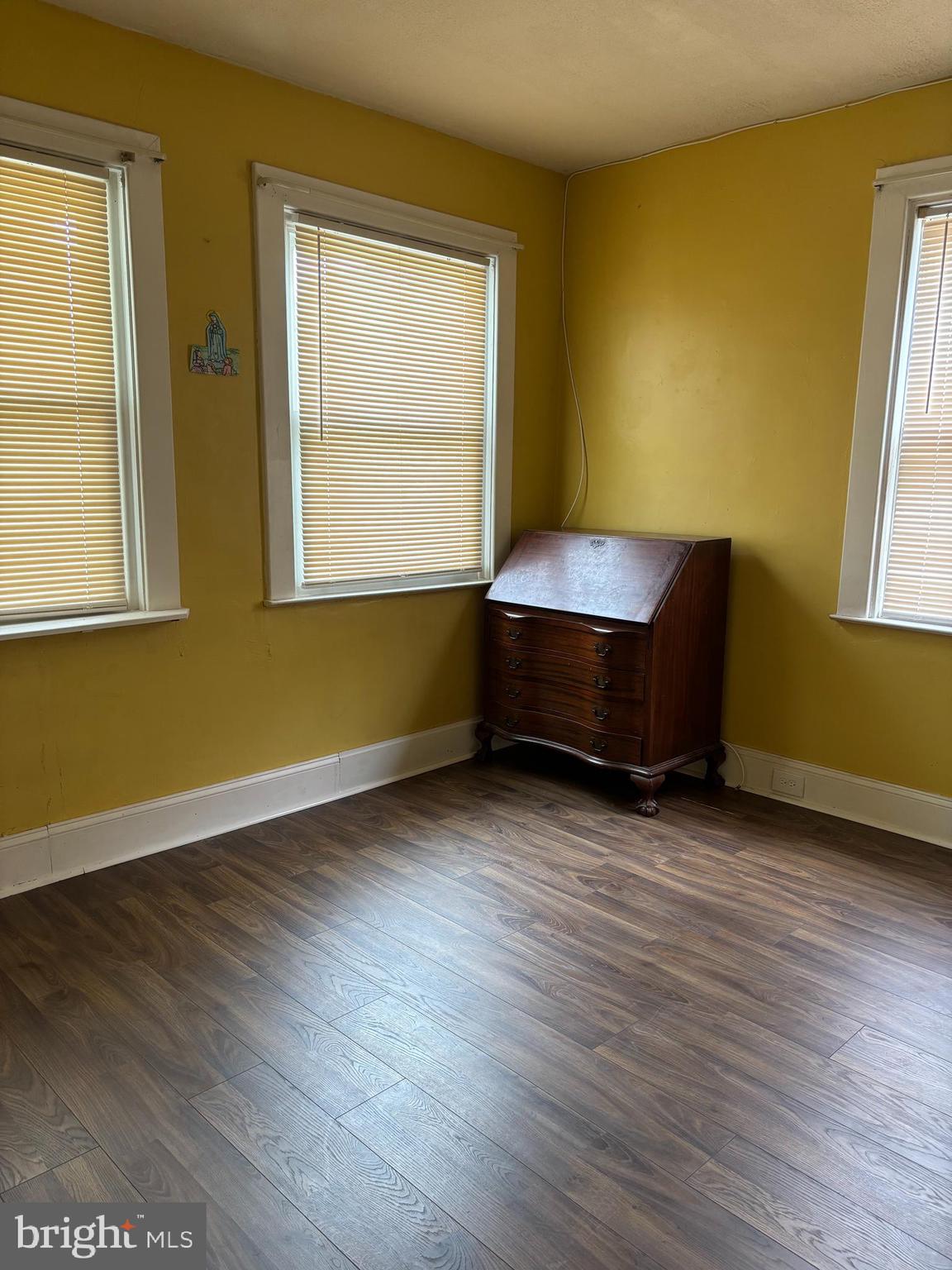 3015 Chesley Avenue Baltimore, MD 21234 - Photo 8 of 30 a view of an empty room with wooden floor and a window