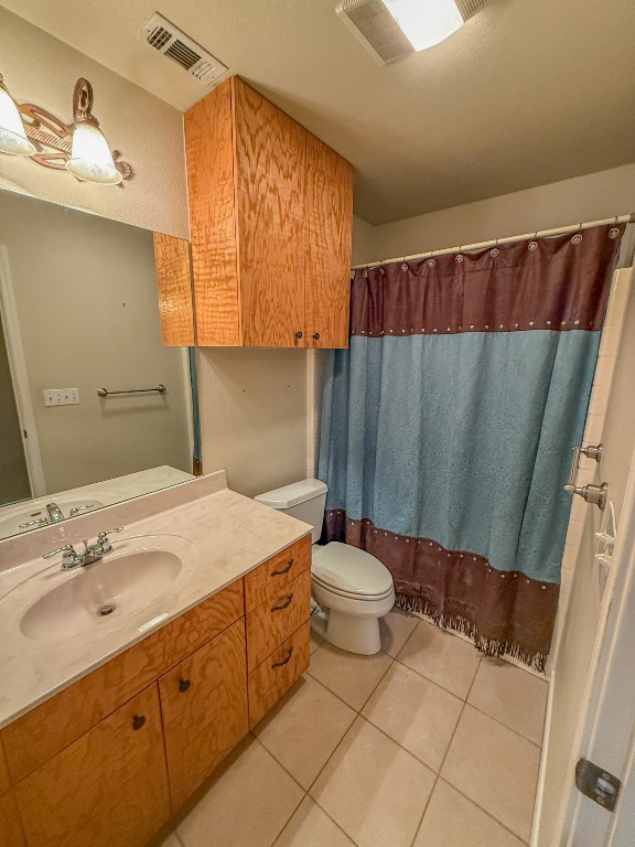 500 Jim Hogg Road Georgetown, TX 78633 - Photo 22 of 37 Bathroom featuring light tile patterned flooring, vanity, and curtained shower