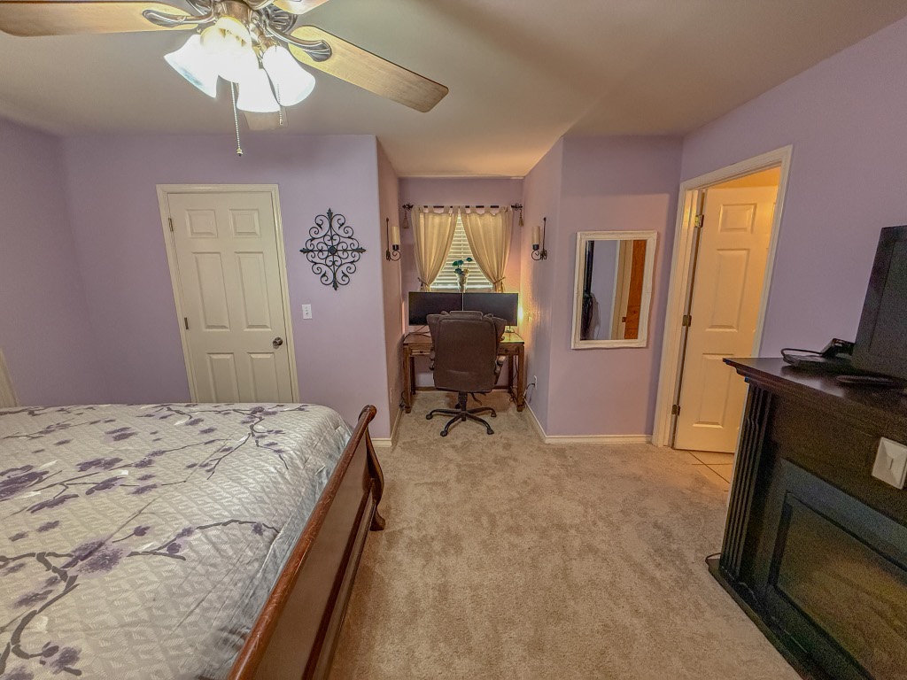 500 Jim Hogg Road Georgetown, TX 78633 - Photo 26 of 37 Bedroom with light carpet, a ceiling fan, and a desk