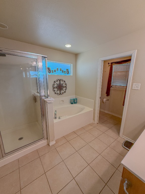 500 Jim Hogg Road Georgetown, TX 78633 - Photo 34 of 37 Full bathroom featuring light tile patterned floors, a bath, a shower stall, and vanity