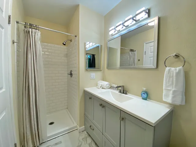 a front view of a house with a yard and trees