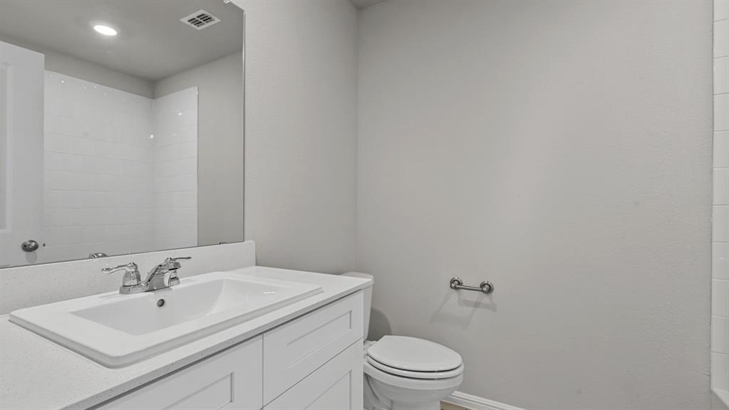 16421 Rangerville Drive Justin, TX 76247 - Photo 34 of 40 a bathroom with a sink toilet and mirror