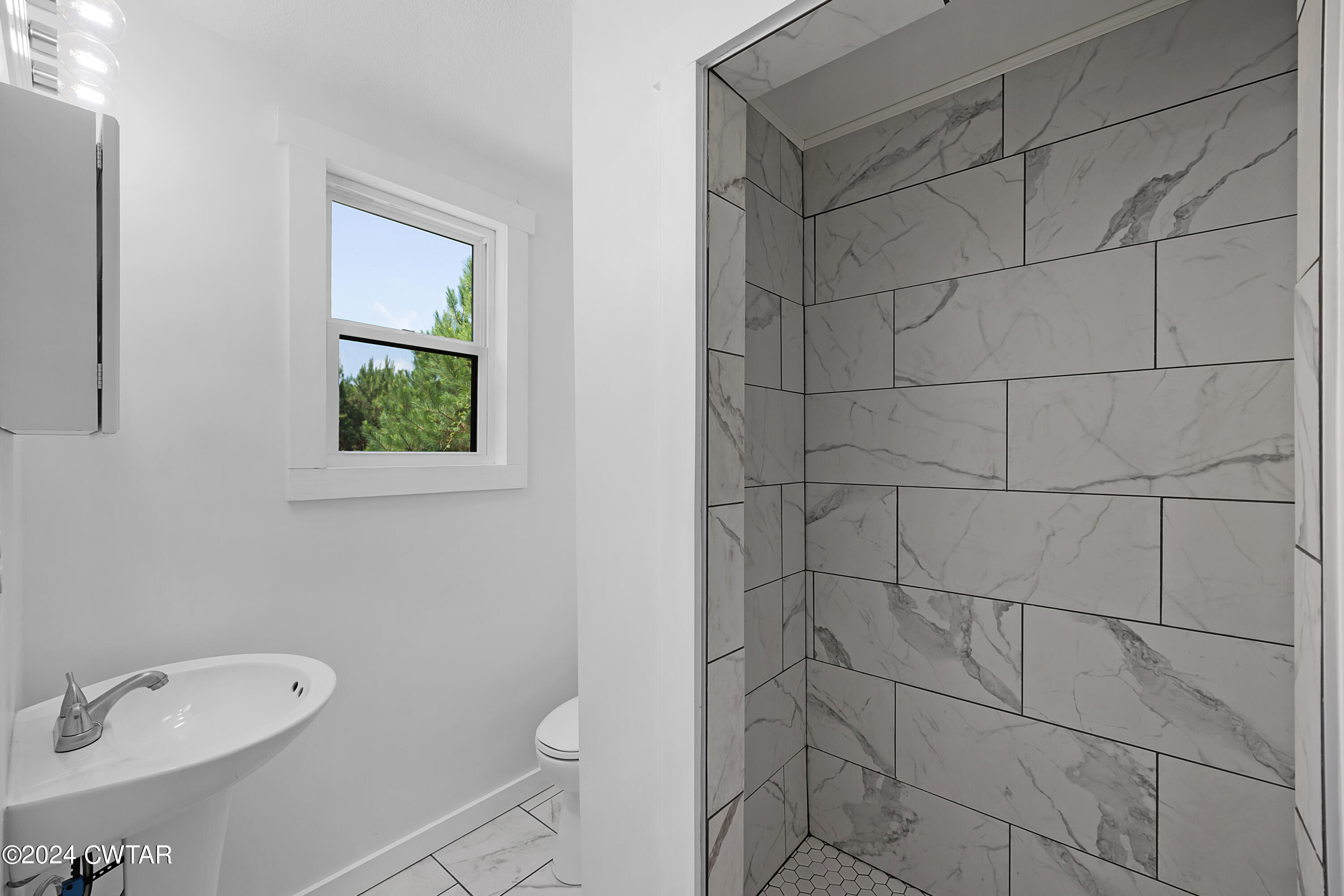 94 McAbee Road Jackson, TN 38301 - Photo 12 of 19 a bathroom with a toilet and a sink