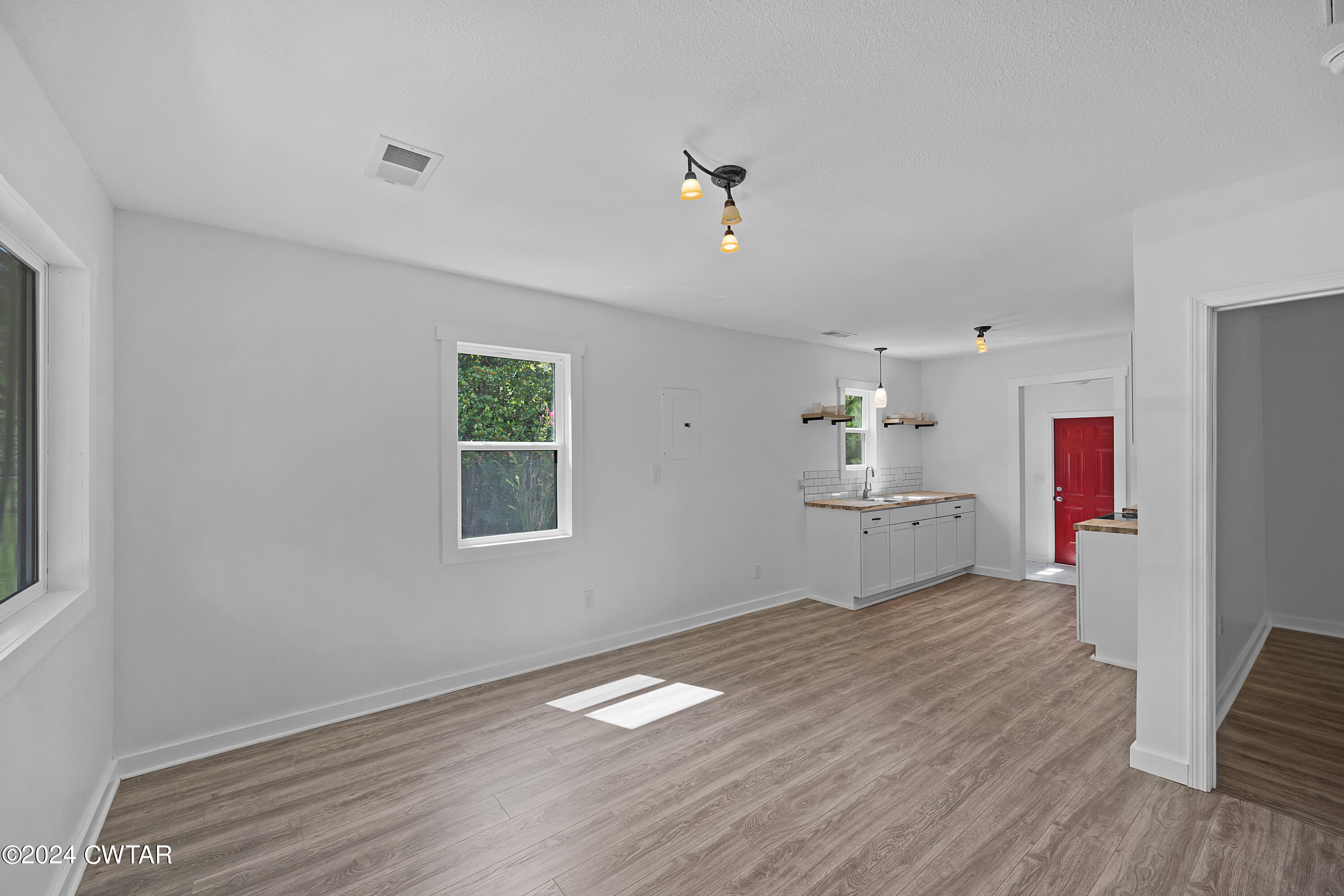 94 McAbee Road Jackson, TN 38301 - Photo 3 of 19 a room with a bed and wooden floor