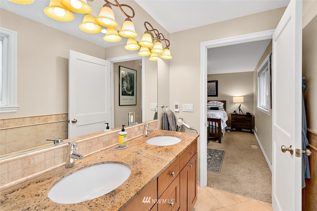 1307 South 9th Street Renton, WA 98057 - Photo 22 of 40 a en suite bathroom with a granite countertop sink and a mirror