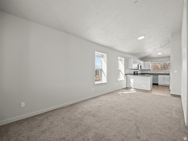 64 West 600 South, Unit C301 Springville, UT 84663 - Photo 6 of 40 Unfurnished living room with light colored carpet and recessed lighting