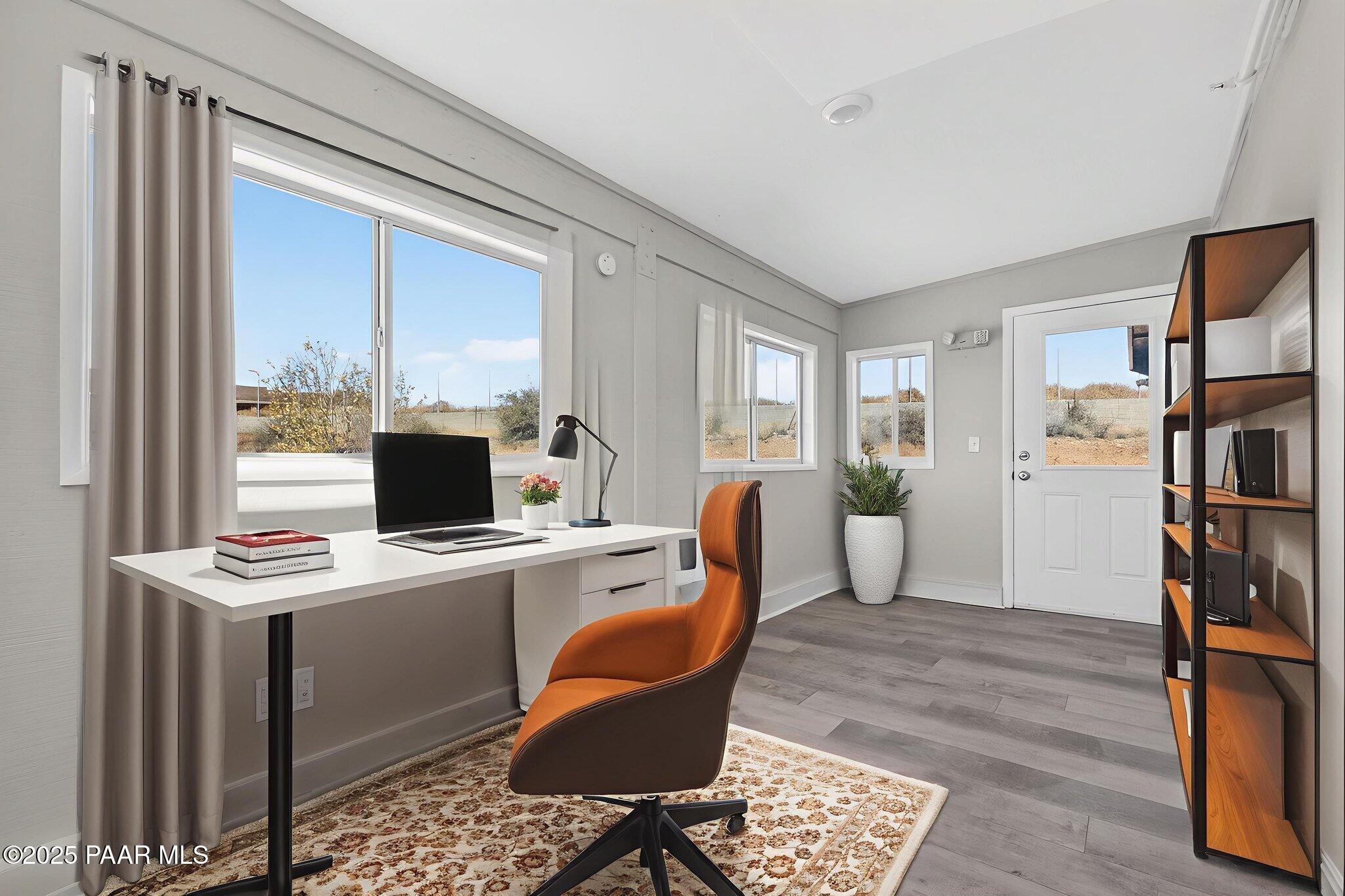 14410 East Blue Ridge Road Dewey-Humboldt, AZ 86327 - Photo 16 of 60 a view of a workspace with furniture and a window
