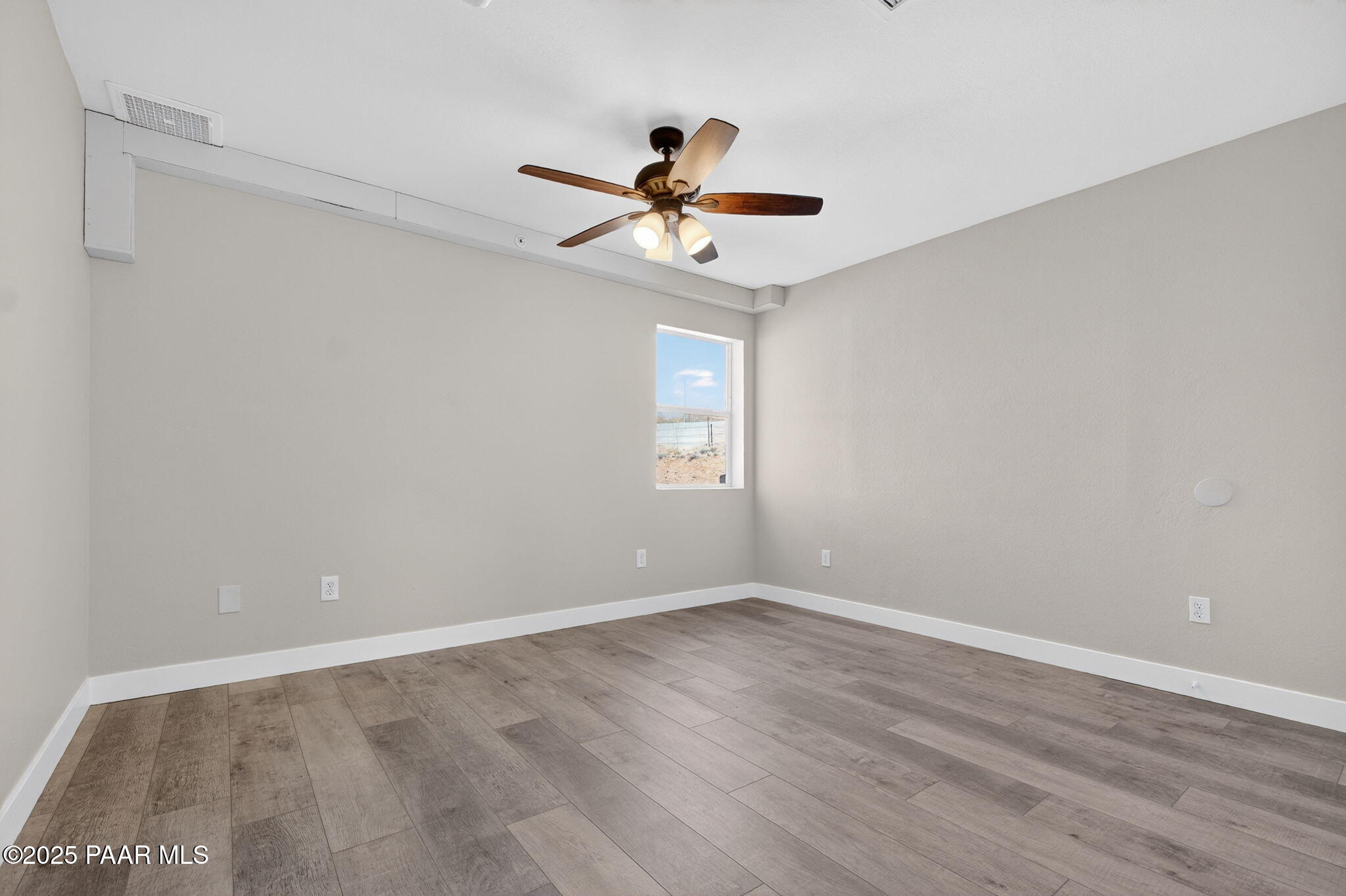 14410 East Blue Ridge Road Dewey-Humboldt, AZ 86327 - Photo 28 of 60 a view of an empty room with window and a ceiling fan