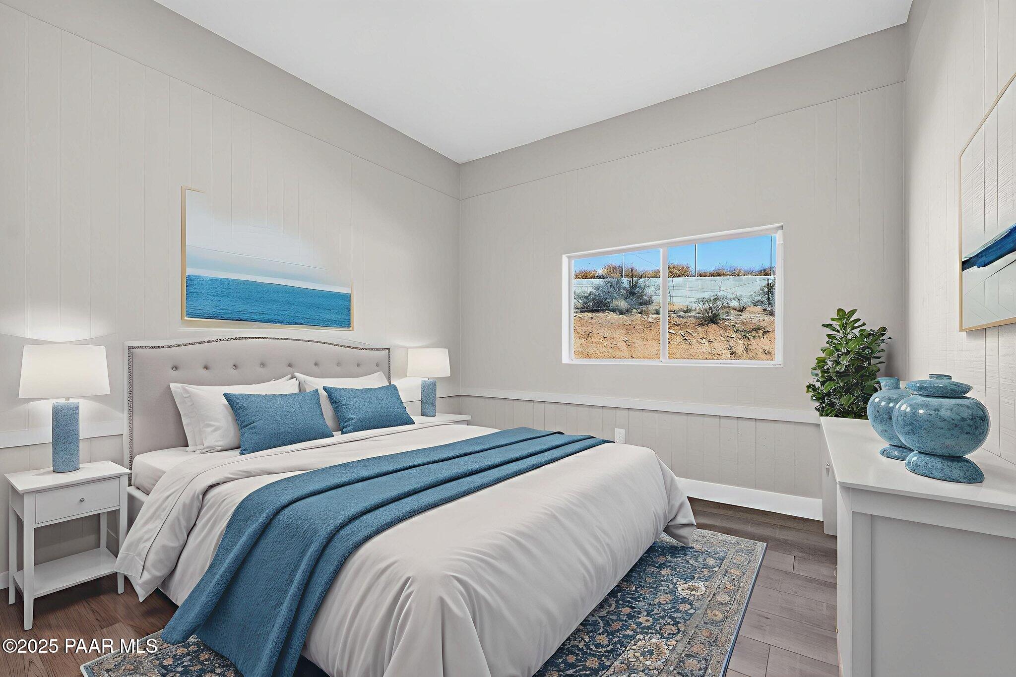 14410 East Blue Ridge Road Dewey-Humboldt, AZ 86327 - Photo 32 of 60 a bedroom with a large bed and a potted plant