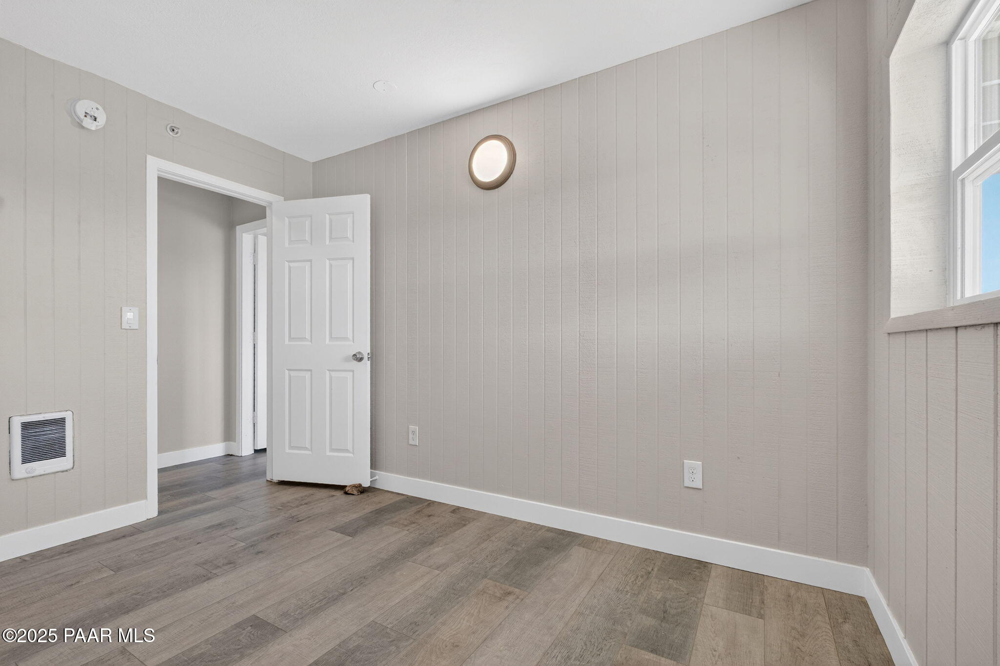 14410 East Blue Ridge Road Dewey-Humboldt, AZ 86327 - Photo 47 of 60 an empty room with wooden floor and windows