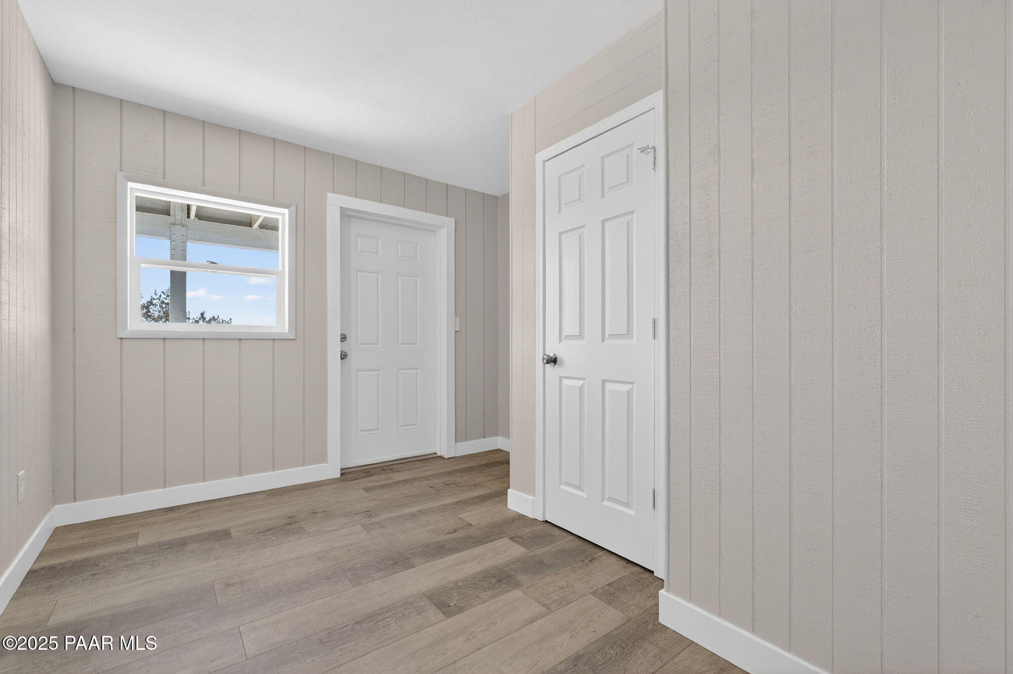 14410 East Blue Ridge Road Dewey-Humboldt, AZ 86327 - Photo 50 of 60 a view of an empty room with wooden floor