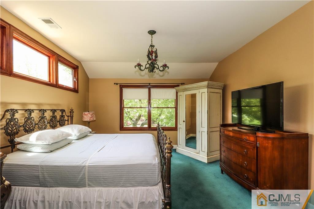 18 Maida Road Edison, NJ 08820 - Photo 14 of 25 a bedroom with a balcony a bed and a flat screen tv