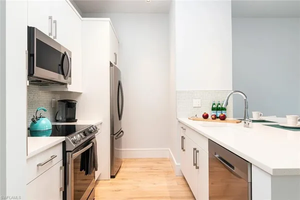 a kitchen with a sink stove and refrigerator