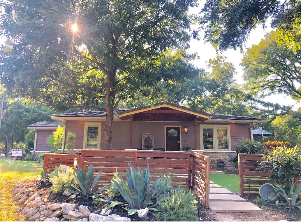 13912 Hummingbird Lane Austin, TX 78732 - Photo 1 of 1 a front view of a house with garden