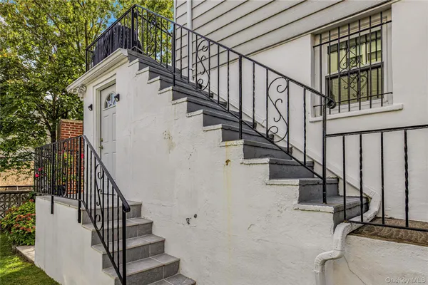 a view of entryway with wooden floor and stairs