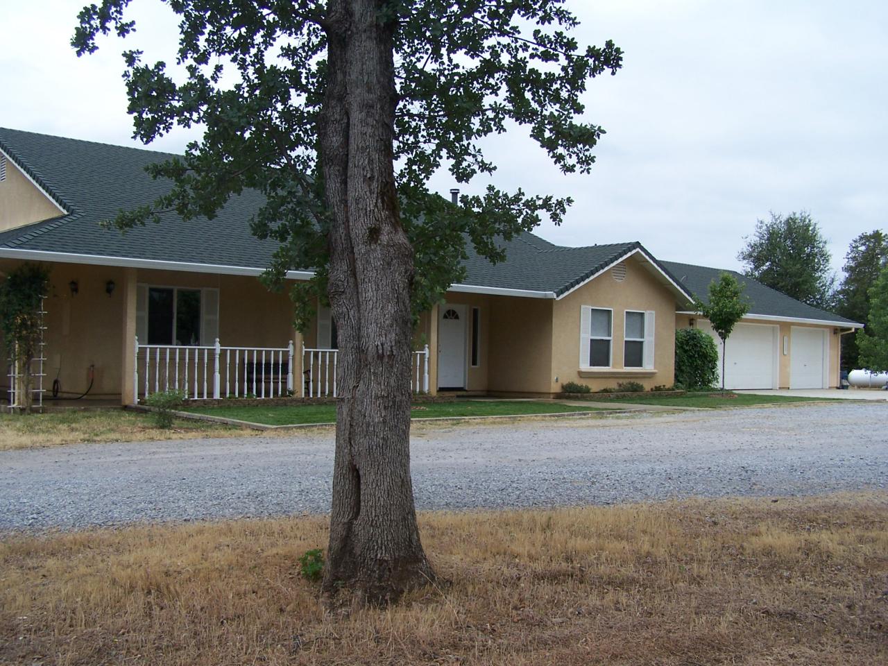 12800 Intermountain Road Redding, CA 96003 - Photo 1 of 39 a front view of a house with a yard and garage