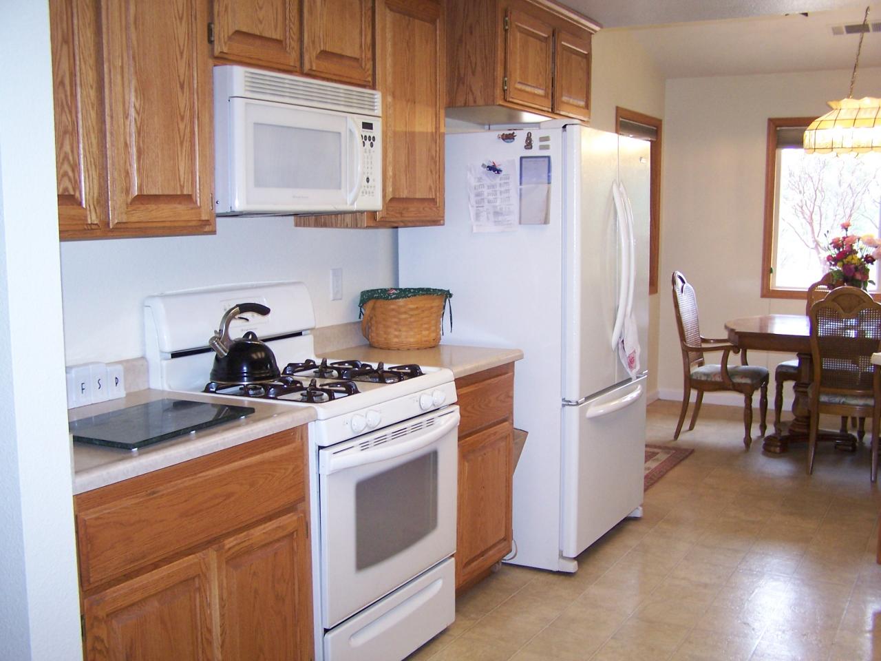 12800 Intermountain Road Redding, CA 96003 - Photo 16 of 39 a kitchen with stainless steel appliances a stove a refrigerator and a cabinets