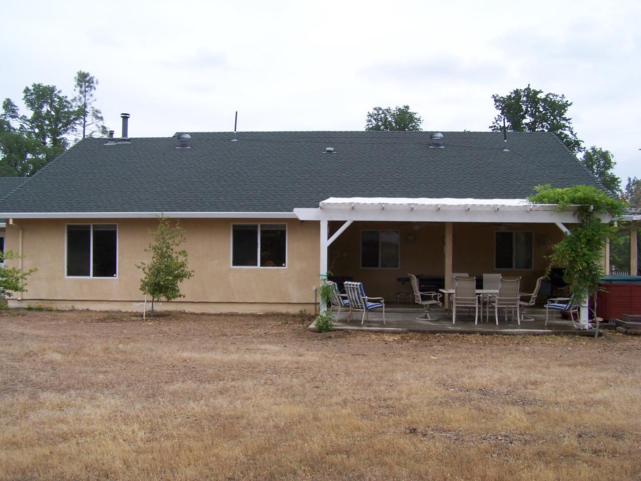 12800 Intermountain Road Redding, CA 96003 - Photo 8 of 39 a backyard of a house with table and chairs