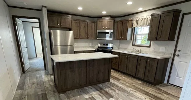 a kitchen with a sink a refrigerator and window