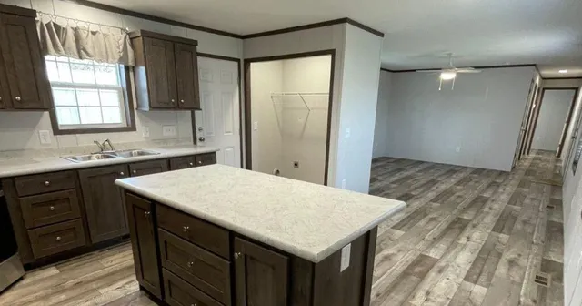 a view of a kitchen with a sink and a refrigerator