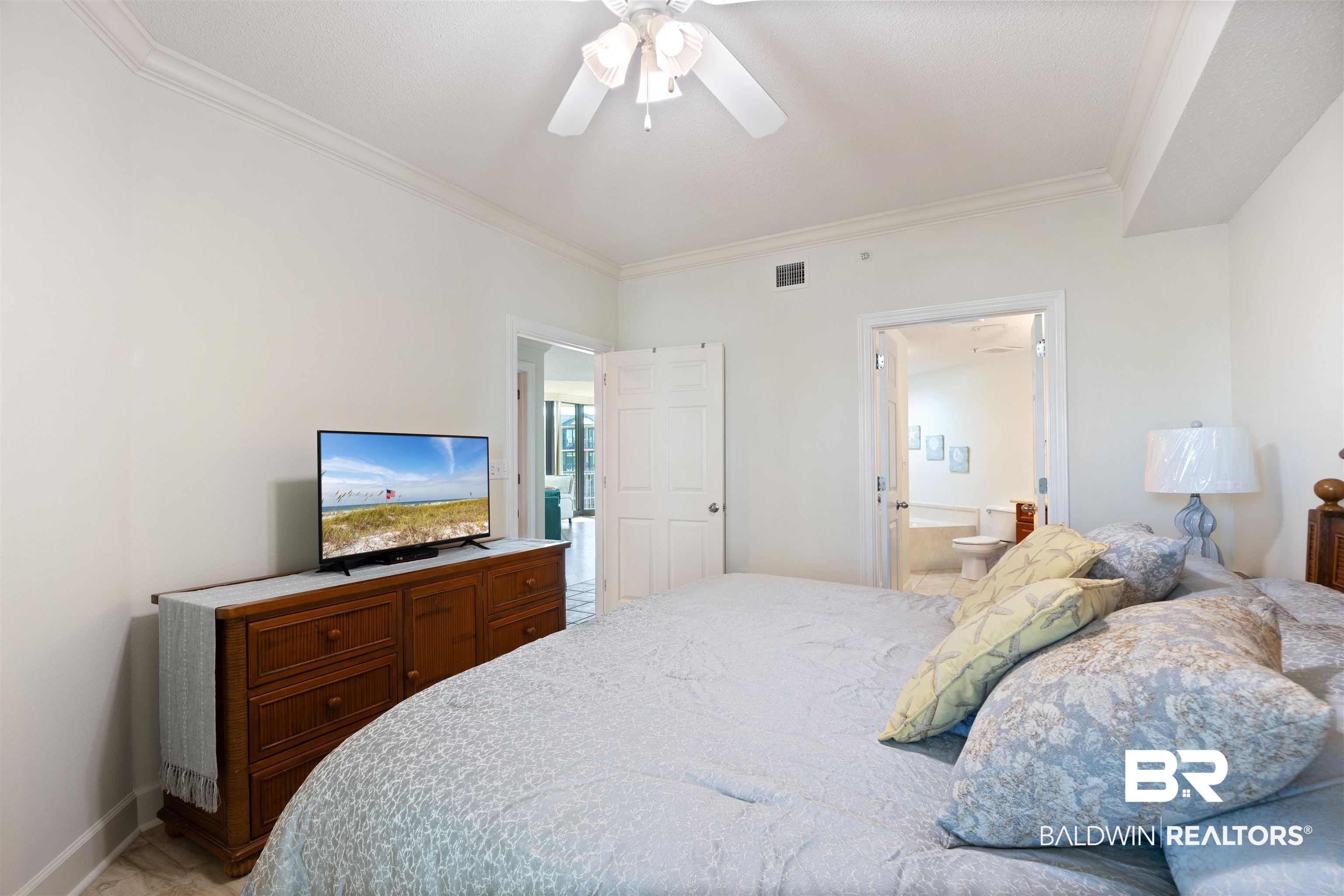 27580 Canal Road, Unit 1431 Orange Beach, AL 36561 - Photo 20 of 73 Bedroom with ornamental molding, ceiling fan, and connected bathroom