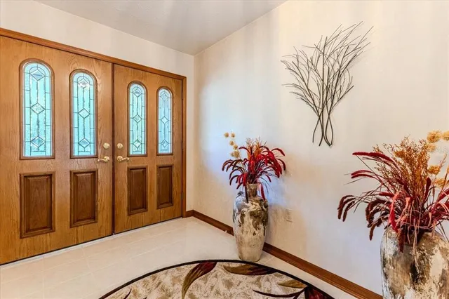 a bathroom with a granite countertop sink and a window