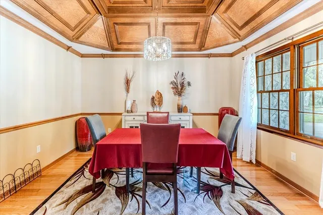 a view of a hallway with wooden floor and entryway