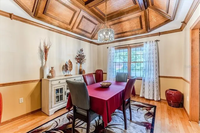 a view of a kitchen with a sink and dishwasher a refrigerator with wooden floor