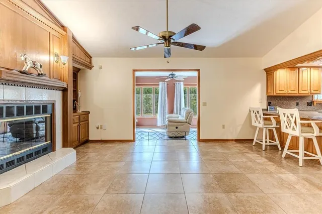 a living room with furniture a flat screen tv and a large window