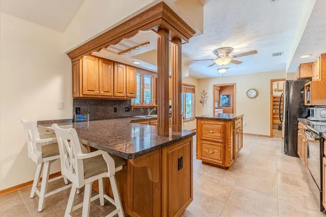 a bathroom with a granite countertop bathtub sink vanity mirror and toilet