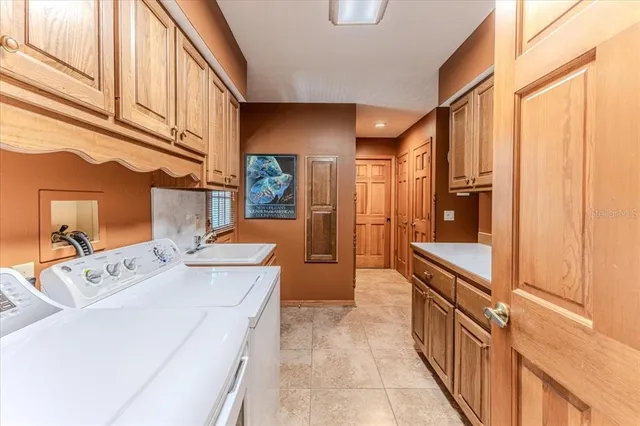 a kitchen with kitchen island white cabinets and stainless steel appliances