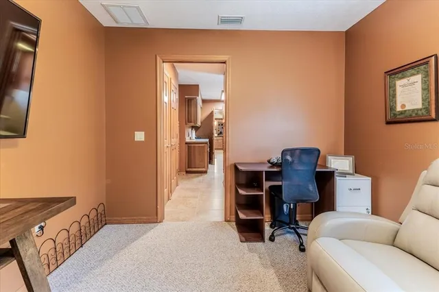 an aerial view of a house with a yard and lake view