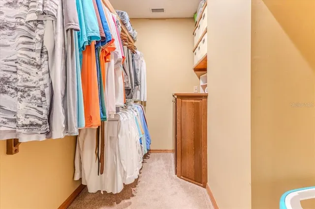 an aerial view of a house with a yard and lake view