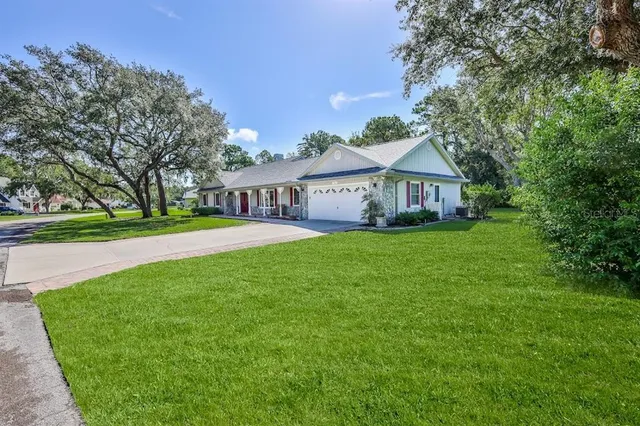 a view of a dining room with furniture a chandelier and wooden floor