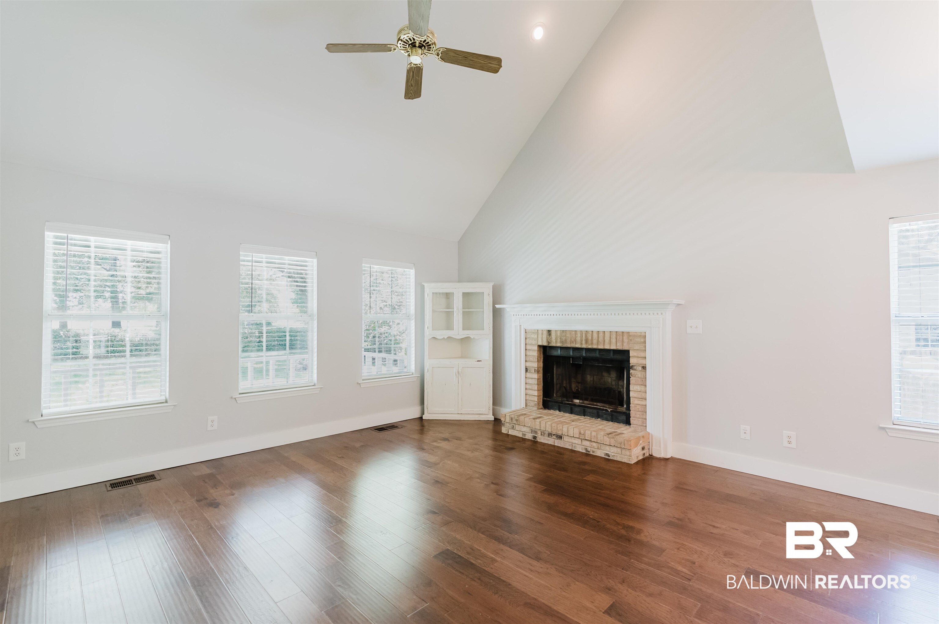 20460 Bishop Road Fairhope, AL 36532 - Photo 9 of 41 Unfurnished living room featuring high vaulted ceiling, plenty of natural light, ceiling fan, and a fireplace