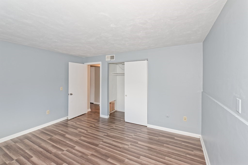 176 Maple Avenue, Unit 27 Rutland, MA 01543 - Photo 7 of 19 a view of an empty room with wooden floor