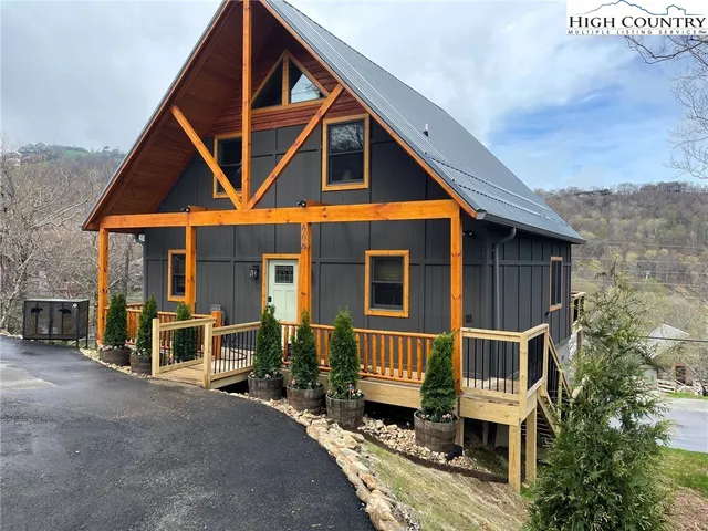 a front view of a house with wooden fence