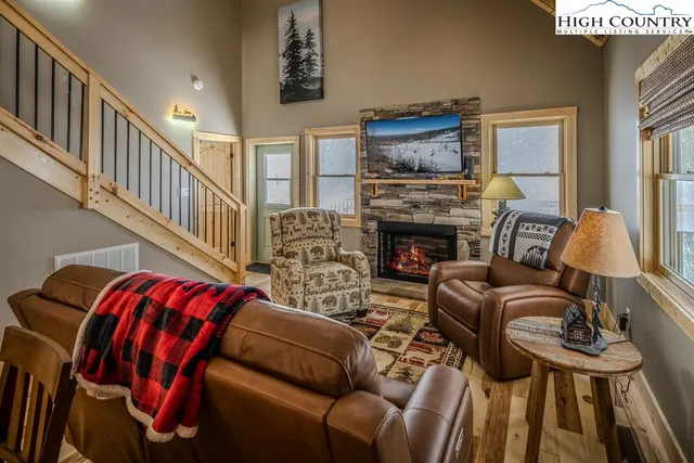 a living room with furniture fireplace and flat screen tv