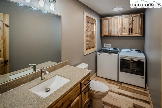 a bathroom with a sink toilet and mirror