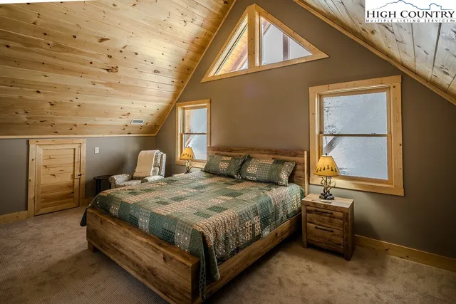 a bedroom with a bed next to a window