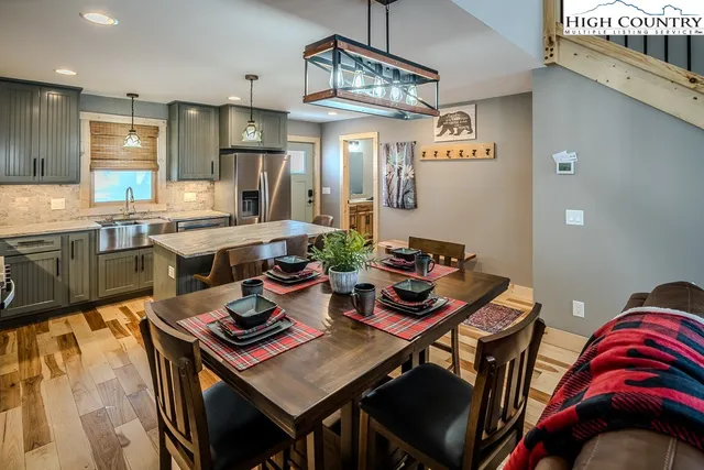 a view of a dining room with furniture and a chandelier