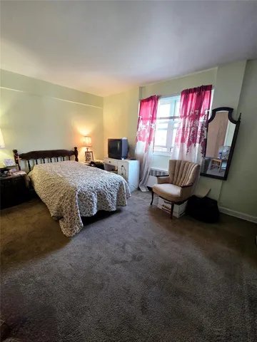 a bedroom with bed and window